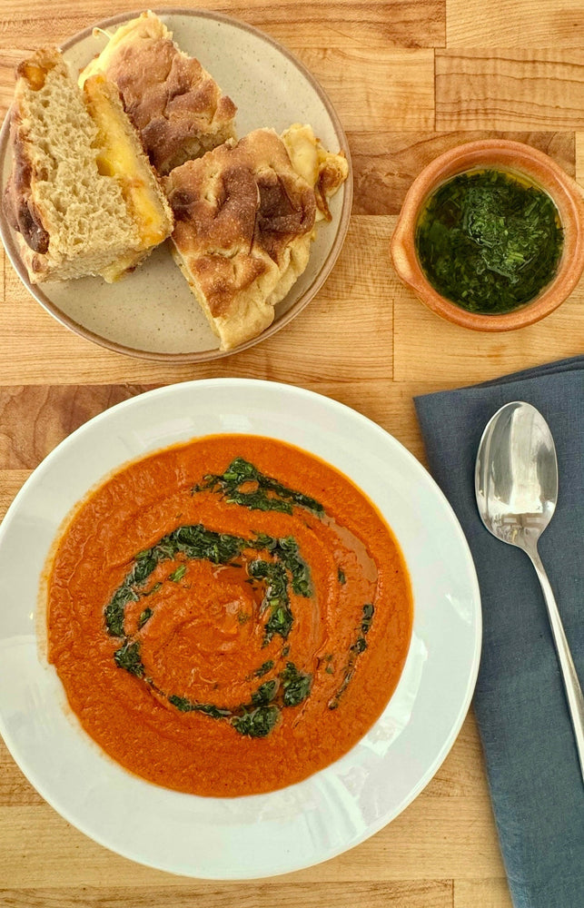 Delicious harissa and tomato soup with foccacia grilled cheese.